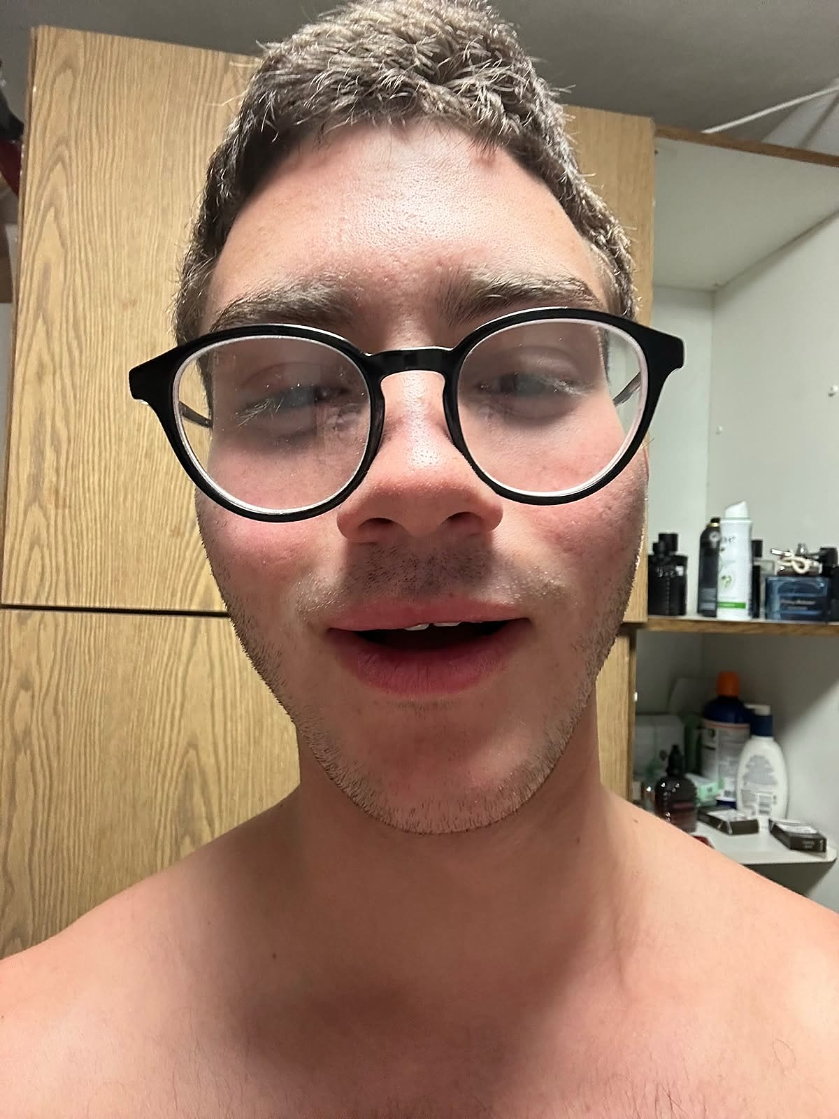 Extreme close-up of Sruly in round glasses