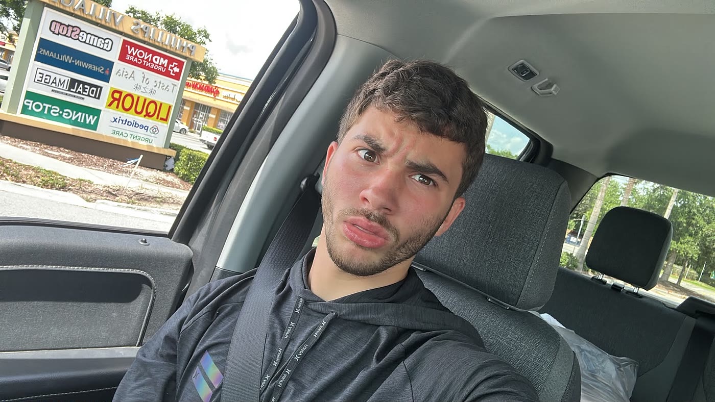 Sruly in a car looking deeply skeptical