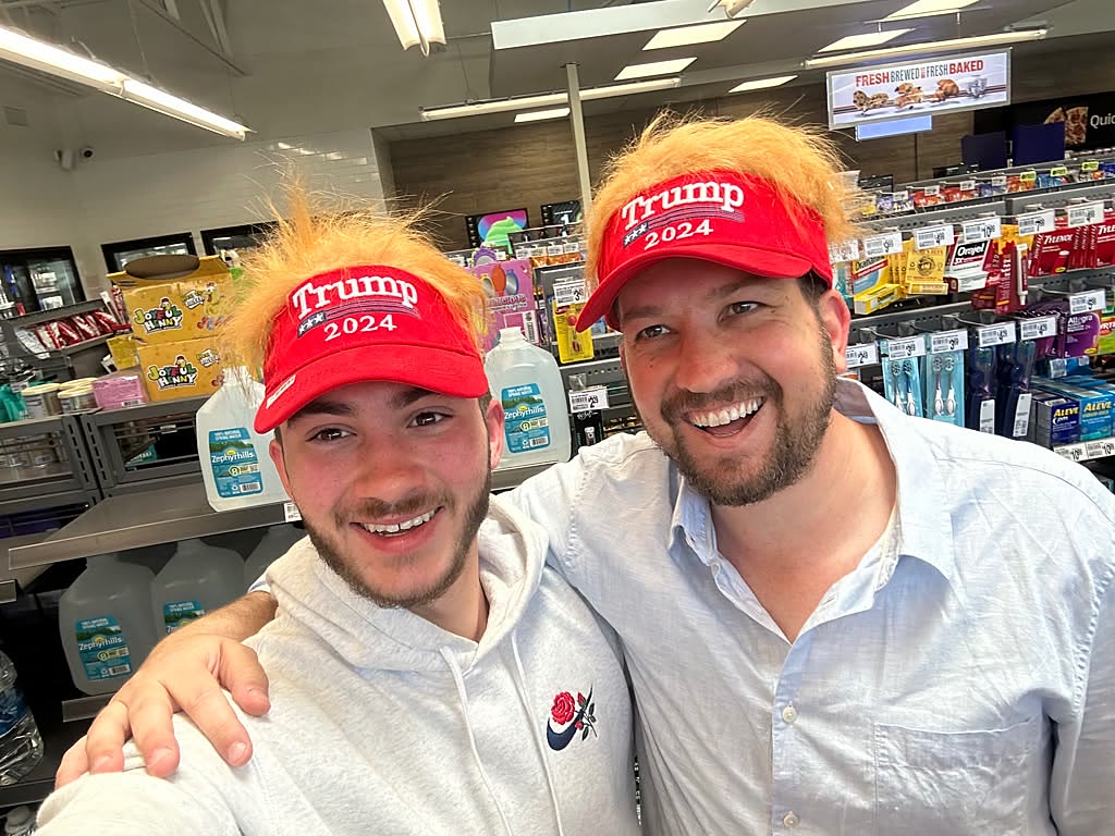 Sruly and a friend in novelty wig hats at a convenience store